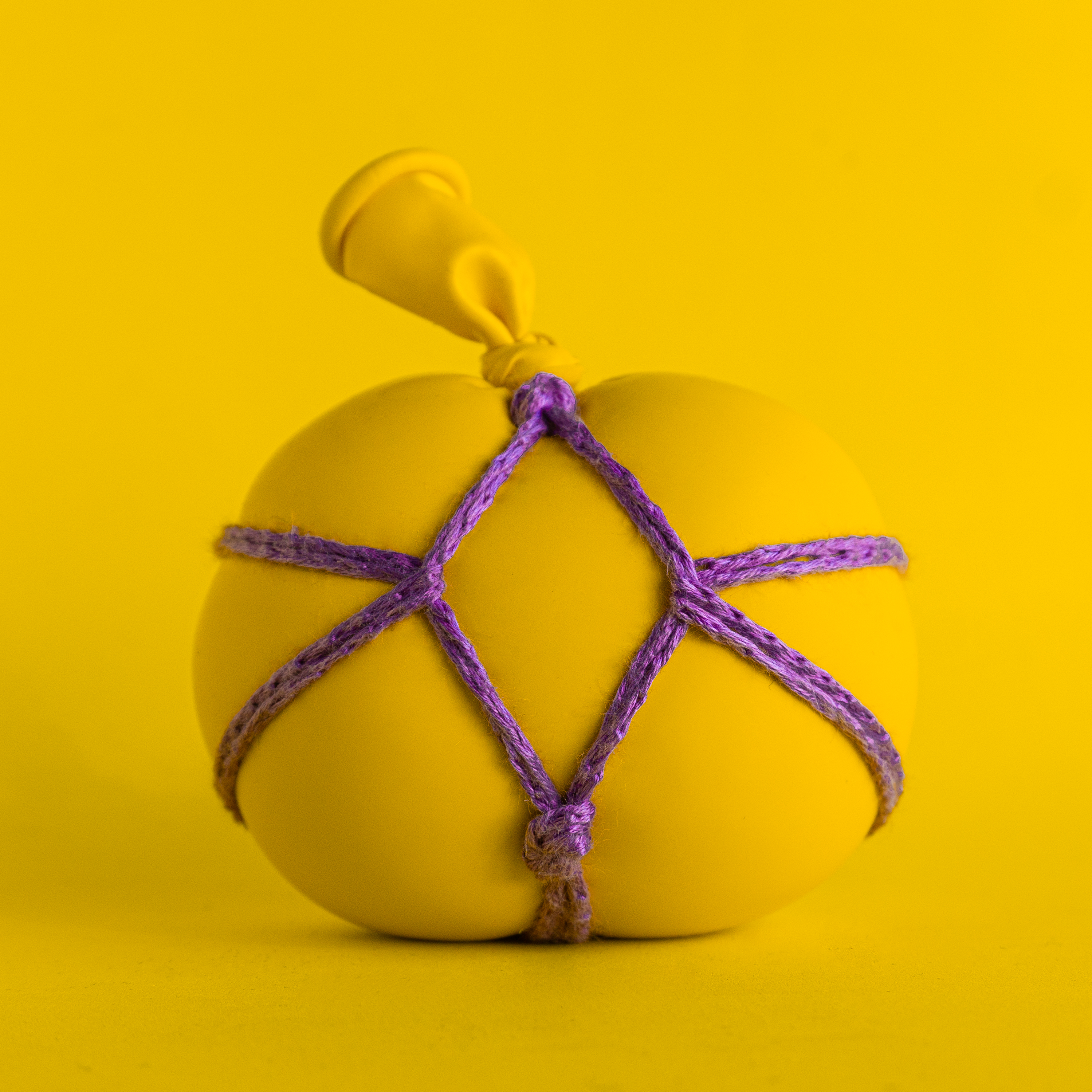 yellow balloon with purple ropework
